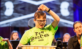 A young musician lifting his arm.